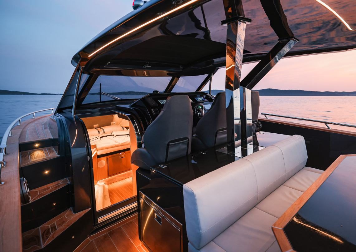 Forza 37 cockpit at dusk with table and lounge seating